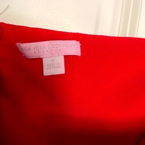 Red strapless jumpsuit with zipper on the back.